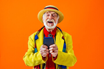 Cool senior man with fashionable outfit portrait - Old and funny grandfather wearing stylish and colorful clothing portrait on colored background