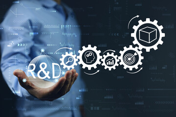 Engineers holding R and D ball on research and development and gear icons as a continuous process as a process. New product development or software development concept.