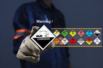 staff with glove holding the corrosive sign one of dangerous substance or goods in the worning list 