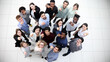 © Katsiaryna - multicultural successful business group looking up in office corridor
