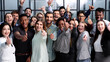 © Katsiaryna - Large Group of people standing together in studio showing thumbs up
