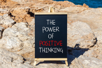 Wall Mural - Positive thinking symbol. Concept words The power of positive thinking on beautiful black chalkboard. Beautiful stone sea background. Business, motivational positive thinking concept. Copy space.