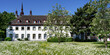 house of the st. heribert old people's home of caritas in cologne deutz in front of a blooming spring meadow