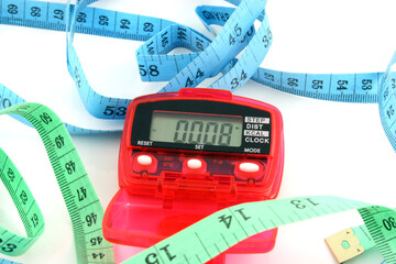 Close up of a Pedometer and 2 tape measures - isolated on a white background