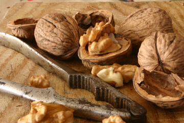 Wall Mural - Walnuts and nutcracker on a wooden board