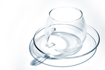 Transparent glass tea cup on a white background