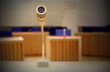 Cloce up of a microphone in a courtroom, focus on the microphone