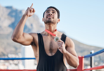 Winning, boxing medal and a man with thanks to God, celebration and sports gratitude. Success, young and a boxer with pride and award from a sport competition and grateful to commitment of a prize