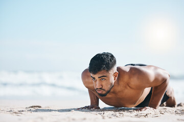 Man, beach and pushup on sand for fitness, workout or exercise for mockup space in summer sunshine. Young guy, bodybuilder and training for health, wellness and strong body with sea mock up on ground