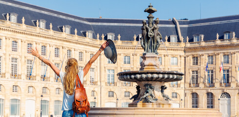 Wall Mural - Happy woman in Bordeaux downtown,  Bourse square with fountain- France