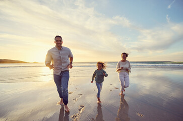 Wall Mural - Mother, father and girl on beach at sunset for family holiday, summer vacation and weekend. Nature, travel and happy mom, dad and child running in ocean waves for bonding, playing and quality time