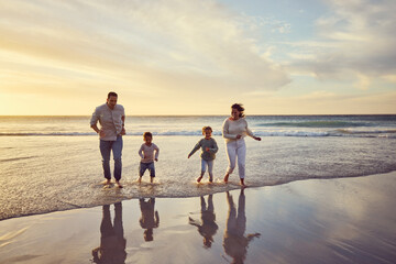 Wall Mural - Beach, sunset and parents play with children on holiday, summer vacation and weekend together. Travel, family and happy mother, father and kids run in ocean for bonding, adventure and quality time