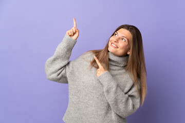 Young Slovak woman isolated on purple background pointing with the index finger a great idea