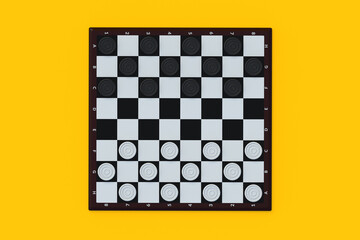 Wall Mural - Draughts on yellow background. Board game. Beginner training. International championship. Pastime with family. Top view. 3d render