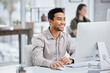 © Graham F/peopleimages.com - Business, smile and man with a computer, connection and administrator with digital planning, search internet and website information. Male person, employee and consultant with a pc and online reading