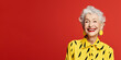 © TimeaPeter - Energetic senior woman isolated on solid red background.