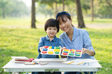 happy holidays, Mum and daughter play together in the park.