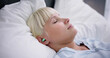 © Andrey Popov - Woman Sleeping With Earplugs In Her Ears