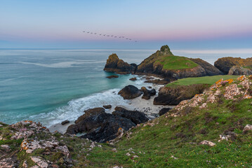 Wall Mural - Beauitful sunrise and sunset landscape image of Kynance Cove in Cornwall England with colourful sky