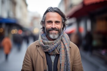 Wall Mural - Portrait of handsome middle-aged man wearing scarf and coat on the street