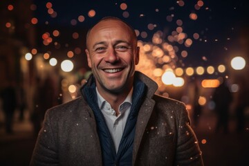 Wall Mural - Portrait of a happy man in the city at night with bokeh lights