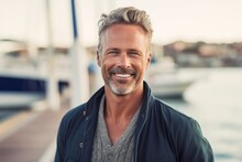 Close-up Portrait Photography Of A Pleased Man In His 40s That Is Wearing A Chic Cardigan Against A Bustling Marina With Yachts And Sailboats Background . Generative AI
