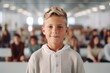 © Anne-Marie Albrecht - Portrait of cute schoolboy with blond hair looking at camera in classroom