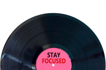 Stay focused symbol. Concept words Stay focused on beautiful black vinyl disk on a beautiful white table white background. Business, support, motivation, psychological stay focused concept. Copy space