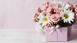 Beautiful bouquet of rose and chrysanthemums flowers and pink gift box on white table background. Gift for holiday, birthday, Wedding, Mother's Day, Valentine's day, Women's Day. Floral arrangement.