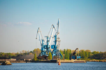 Larger cranes in the port, cranes load bulk materials. The work of cranes in the seaport