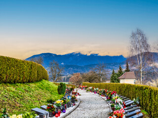 Poster - Row and graves in Kamnik cemetery and the mountain in the background during senset, Kamnik, Slovenia