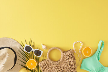 Sticker - The idea of a beach retreat during the summer. Top view flat lay of beach accessories, juicy orange, palm leaf, seashell on yellow background with blank space for advert or text