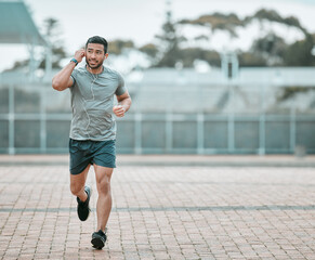 Sports, exercise and man running with earphones for music, radio or podcast for motivation. Fitness, energy and athlete runner doing outdoor cardio workout for race, competition or marathon training.