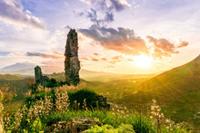 Beautiful Medieval Castle Ruins On Mountain During Nice Sunset Or Sunrise With Highland Landscape On Background