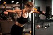 © ty - Fit women doing push ups training arms with trx fitness straps in gym.