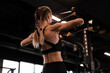 Women doing pull ups training arms with trx fitness straps in the gym. Upper body training. Back view.