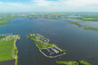 Drone image of a lake in Friesland with small sailboats and island