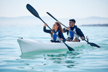 Kayak, Couple And Rowing Boat On Lake, Ocean Or River For Water Sports And Fitness Challenge. Man And Woman With A Paddle For Adventure, Exercise Or Travel In Nature With Freedom, Energy And Teamwork