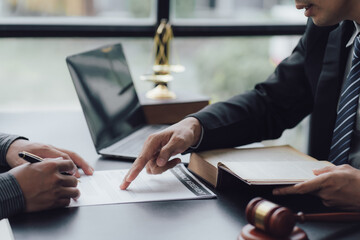 Lawyer man holding pen with contract or agreement document to the customer for signing in courtroom legal, Sign a contract business.