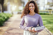 © Matthew C/peopleimages.com - Portrait, woman with books and student in campus garden, university and education with learning material for studying. Female person outdoor, academic scholarship and mockup space and college course