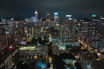 View from above of brightly illuminated high skyscraper buildings in downtown district of Atlanta city in Georgia, USA. American megapolis with business financial district at night