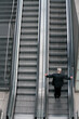 Man on escalator.