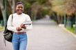 © Michael Cunningham/peopleimages.com - Black woman, books and portrait of student at college, university or person ready for learning, goals or education. Girl, face and happy learner studying on campus or walking outdoor with backpack