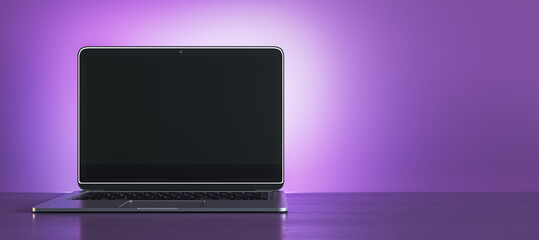Wall Mural - creative purple designer workplace with empty black mock up laptop display. 3d rendering.