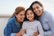 Happy latin multi generational family having tender moment together outdoor - Female child smiling on camera