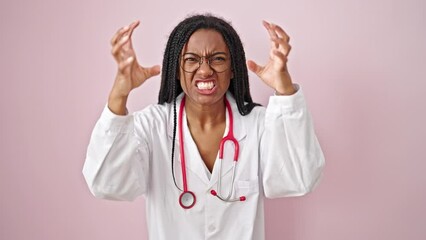 Poster - African american woman doctor angry and stressed over isolated pink background