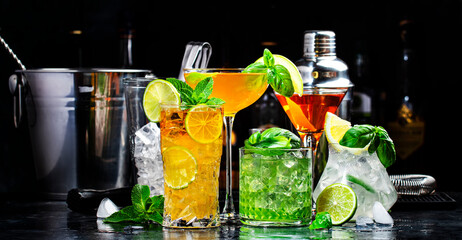 Cocktail party, alcohol drinks with gin, whiskey, vermouth and liquor, black bar counter background, nightlife atmosphere