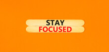 Stay focused symbol. Concept words Stay focused on beautiful wooden stick on a beautiful orange table orange background. Business, support, motivation, psychological stay focused concept. Copy space.