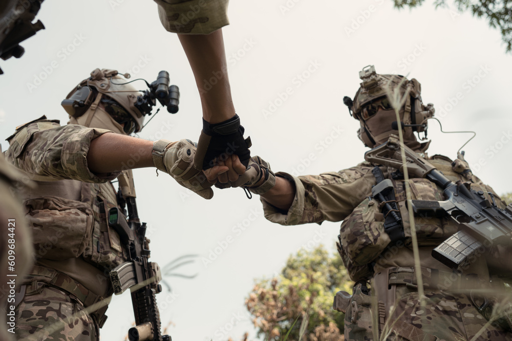 Special forces soldier in camouflage, fist bump and send energy to each ...