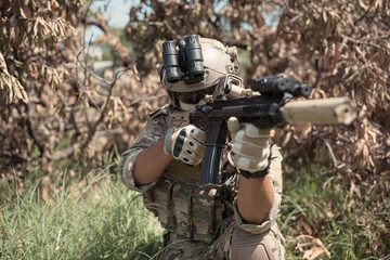 Special forces soldier in camouflage with a pair of weapons that are full of modern technology and complete for battle